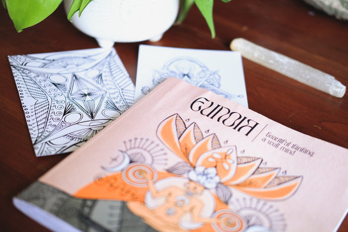 An open coloring book adorned with intricate designs and patterns, perfect for promoting mindfulness, relaxation, and overall well-being through creative expression
